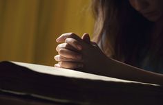 a woman holding her hands over a book with the words your strength is found in christ you simply need to walk in it