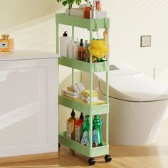 a bathroom with a white toilet and green shelf