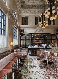 an ornately decorated restaurant with chandeliers and seating