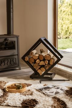 a pile of wood sitting on top of a rug next to a stove