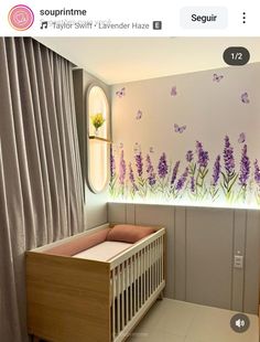 a baby's room with purple flowers and butterflies painted on the wall, along with a crib