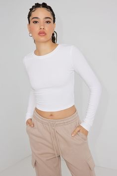 Your new go-to long sleeve. Features - Crewneck - Ribbed Size & Fit - Fit: Fitted - Length: Cropped - Model is wearing size S Materials & Care - Content: 92% viscose, 8% spandex - Care: Machine wash, cold - Imported White Long Sleeve Shirt Cropped, White Ribbed Long Sleeve Top, Long Sleeve White Top Outfits, Long Sleeve Crop Top Outfits, Tight Shirt Outfit, White Crop Top Long Sleeve, White Long Sleeve Shirt Outfit, Billie Concert, Long Sleeve White Shirt