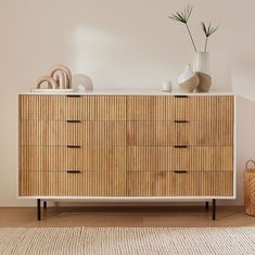 a large wooden dresser sitting on top of a hard wood floor next to a white wall