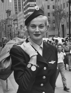 a woman in uniform is walking down the street