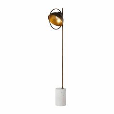 a floor lamp with a white marble base and an orange light bulb on the top