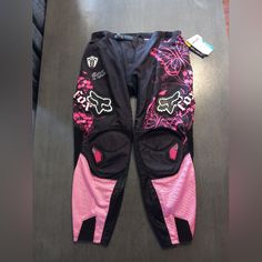 a pair of pink and black pants sitting on top of a table