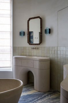 a bathroom with a sink, mirror and bathtub in the corner next to a window