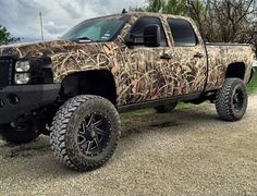 the truck is camouflaged and ready to be used in the country or on the road