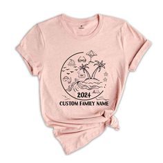 a women's pink t - shirt with an image of the family name on it