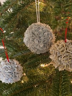 three ornaments hanging from a christmas tree