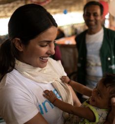 a woman holding a small child in her arms