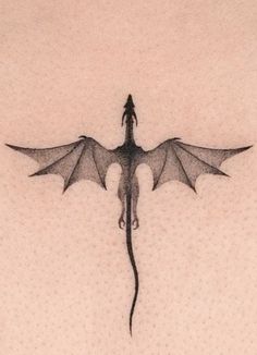 a black and white photo of a dragon tattoo