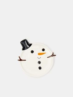 a white plate with a snowman face on it's side and black top