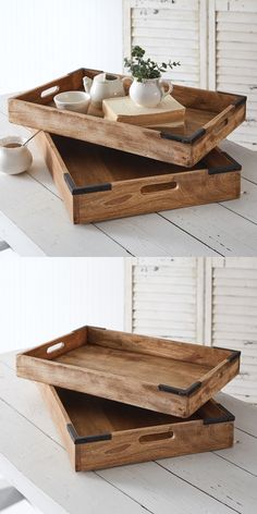 two wooden trays sitting on top of each other