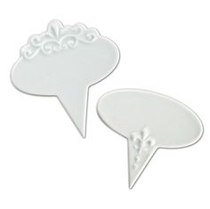 two white plastic speech bubbles on a white background