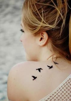 the back of a woman's neck with birds on it and an instagram