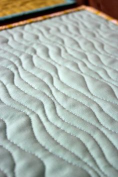 closeup of the quilted edge of a bed