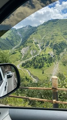 a view from inside a car looking at the mountains and valleys in the valley below