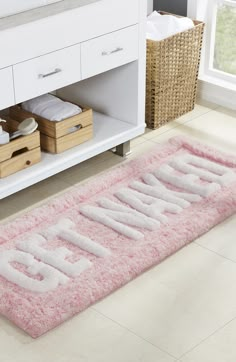 a pink bathroom rug that says go with it