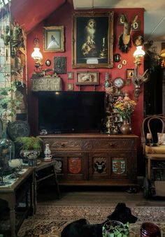 a living room filled with lots of furniture and pictures on the wall next to a flat screen tv