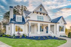 a white house with blue trim and windows