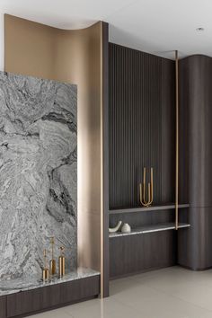 an elegant bathroom with marble and gold accents