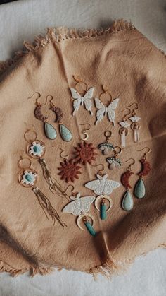 a piece of cloth with various earrings on it