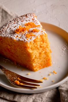 a piece of cake sitting on top of a white plate with a fork next to it