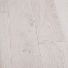 white wood flooring is shown in this close up shot, with the light colored finish