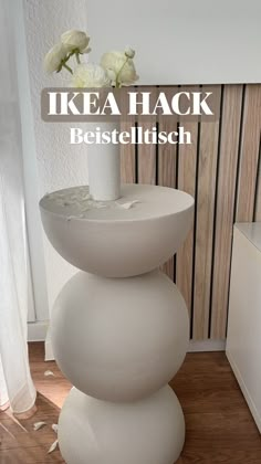 there is a white vase with flowers on top of it and the words ikea hack