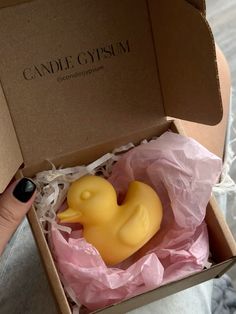 a small yellow rubber duck in a box