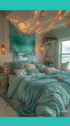 a bed with blue sheets and lights hanging from the ceiling