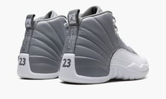 The Air Jordan 12 “Stealth” is a versatile, two-tone grey-and-white colorway of the retro basketball shoe.  Originally released in 1997, the Jordan 12 was worn by Michael Jordan with the Chicago Bulls during the ‘96-97 NBA season, and in the ‘97 NBA Playoffs.  Here, the “Stealth” honors the shoe’s 25th anniversary, and it doesn’t disappoint.  Details include a Stealth Grey tumbled leather upper paired with a white pebbled mudguard.  The color block is reminiscent of the Jordan 12’s “Obsidian” co Jordan 12 Stealth, Grey Jordans, Cheap Jordan Shoes, Jordan Retro 12, Nba Fashion, Retro Basketball Shoes, Air Jordan 12, Jordan Shoes Retro, Retro Basketball