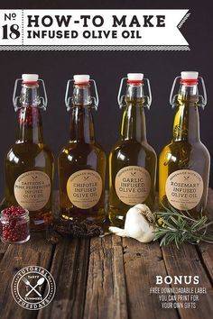 three bottles of olive oil on a wooden table with herbs and spices in front of them