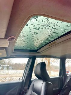 the interior of a car with lots of glass on it's roof and windshield