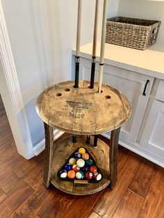 an old wooden table with pool balls on it and two candles in the middle,