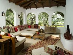 a living room filled with furniture and lots of windows