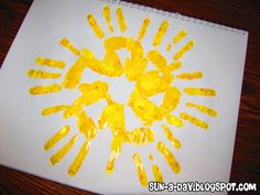 an art project with yellow handprints on white paper