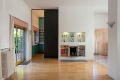 a living room filled with furniture and a fire place next to a wall mounted heater