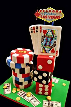 a cake made to look like playing cards and dices on top of each other