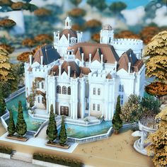 a model of a large white castle surrounded by trees