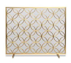 a gold and white screen with circles in the middle, on a wooden stand against a white background