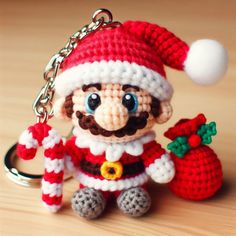 a crocheted keychain with a santa clause hat and bell on it