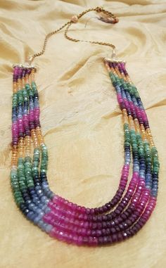 This is a five strand multicoloured sapphire necklace with a highly adjustable length. Bead size is 2-4mm. The necklace was handmade in Hyderabad, India which is renowned for crafting exquisite and intricate designs and has a rich history in the art of jewellery making which dates back centuries. The artisans in Hyderabad are skilled in creating unique designs that often incorporate cultural and historical elements, making the jewellery not just a fashion statement but also a piece of art. The c Luxury Double Strand Gemstone Beaded Necklaces, Luxury Multicolor Long Beaded Necklaces, Multicolor Round Beads Jewelry For Celebration, Multicolor Gemstone Beaded Necklaces With Oval Beads, Elegant Multicolor Beaded Necklaces As Gift, Elegant Multicolor Beaded Necklaces For Gifts, Elegant Multicolor Beaded Necklace For Gift, Elegant Multicolor Rondelle Beaded Necklaces, Multicolor Multi-strand Jewelry For Gifts