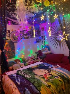 a bedroom decorated with colorful lights and stuffed animals on the bed in front of it