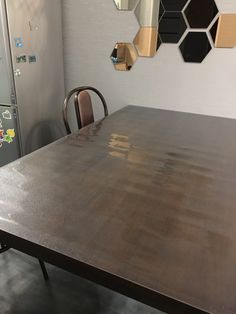 a wooden table and chairs in a room with hexagonal mirrors on the wall