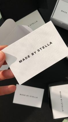 a person holding up a business card that reads made by stella