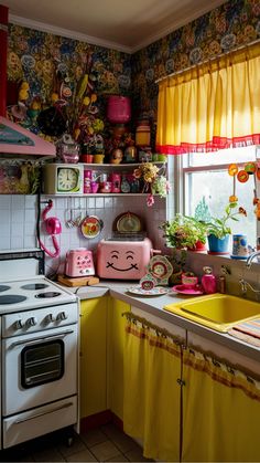 a kitchen filled with lots of clutter next to a window