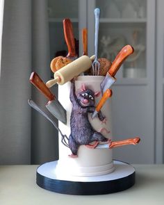 a cake decorated to look like an animal holding knives