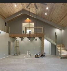 an empty room with stairs and ladders in it